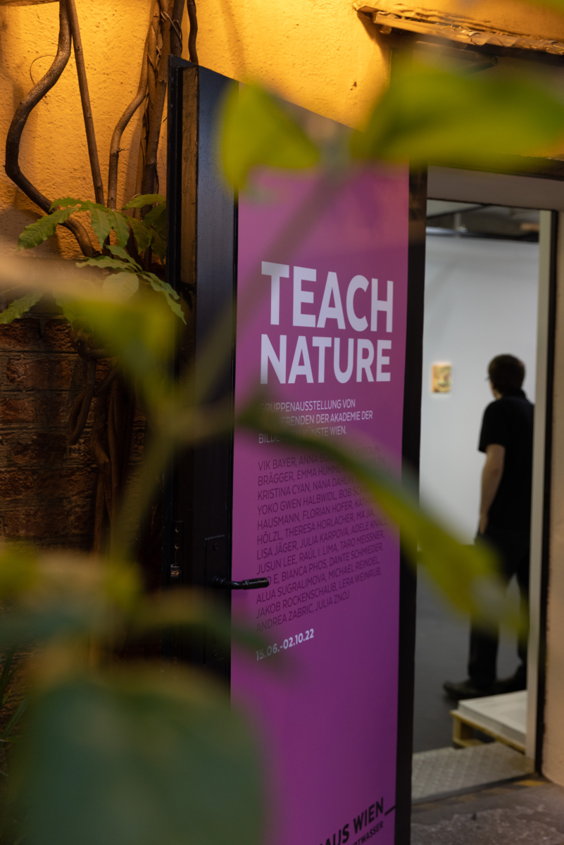 Offener Eingang zur Ausstellung mit beschrifteter Tür; darauf steht TEACH NATURE